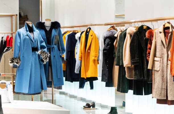 female overcoat in modern clothing store - merchandise luxury equipment fashion industry imagens e fotografias de stock