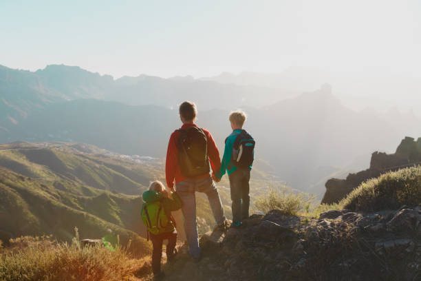 istock Father with kids travel in sunset mountains 1137552176