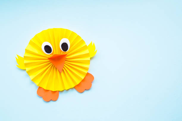 istock Happy, cute, yellow chick folded and created from paper on pastel blue background. Empty place for text, quote or sayings. Top view. 1137552331