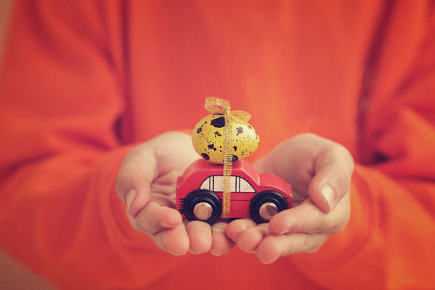 Child hands holding yellow easter egg. Holiday concept. Toned image.