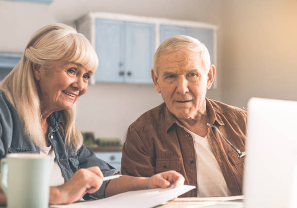 istock Happy old man and woman planning retirement with computer 1137556831