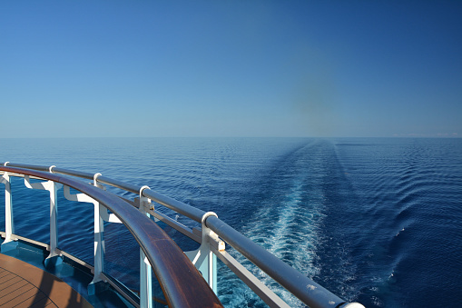 Wake of the cruise ship at see seen from open deck.