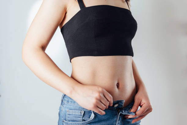 istock Beautiful Woman Opening jeans Button 1137559850