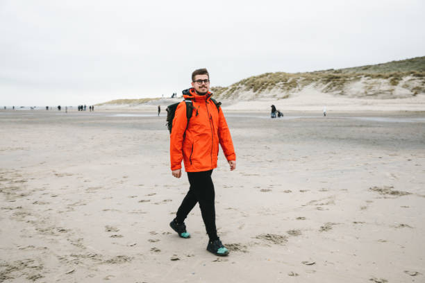 istock Man walking at beautiful beach on Texel island 1137560876