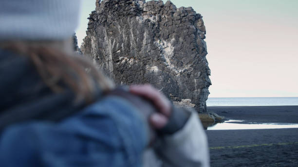Young multi ethnic couple enjoying the view on a black beach