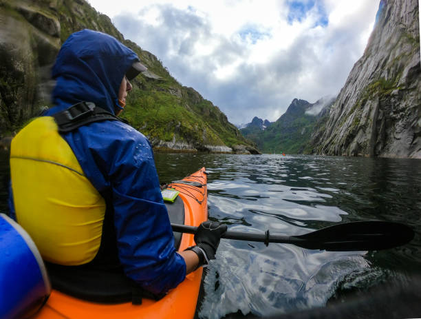istock Image from back of female tourist with paddle canoe floating along river 1137563091