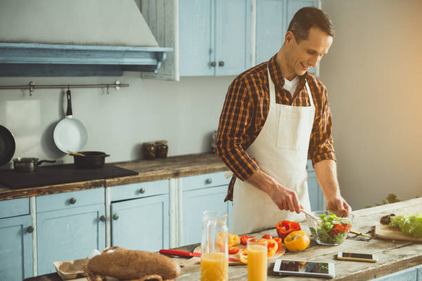 istock Smiling guy being fond of cooking 1137564014