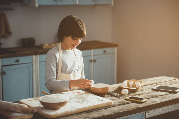 istock Little boy in apron making dough 1137564050