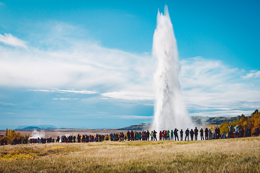 A crowd admiring an eruption of Stokkur geyser on Iceland