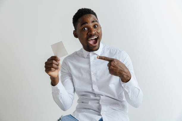 istock Young afro man with a surprised happy expression won a bet on gray studio background. 1137565819