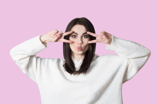 istock young woman  on a pink background gesturing with hands. 1137565953