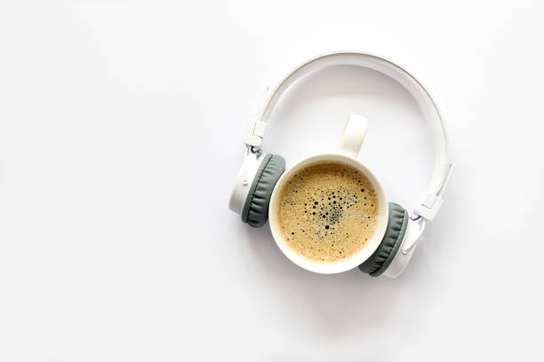 istock Wireless headphones and cup of coffee on white background. Top view. Copy space 1137566584