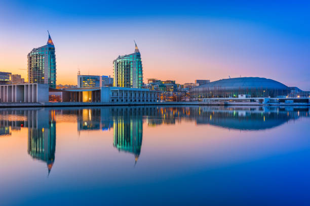 Lisbon, Portugal: Sunset at The Nations Park (Parque das Nações) in Lisbon. Modern buildings and Altice Arena mirrored in the water stock photo