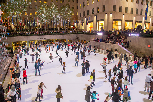 New York, United States of America - November 19, 2016: People on the ice skating rink at the famous Rockefeller Center