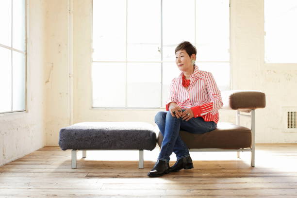 istock Senior woman sitting on sofa 1137571680