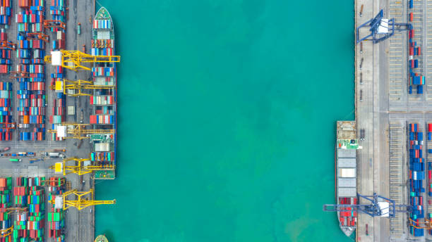 istock Container ship in export and import business logistics and transportation. Cargo and container box shipping to harbor by crane. Water transport International. Aerial view and top view. 1137572843