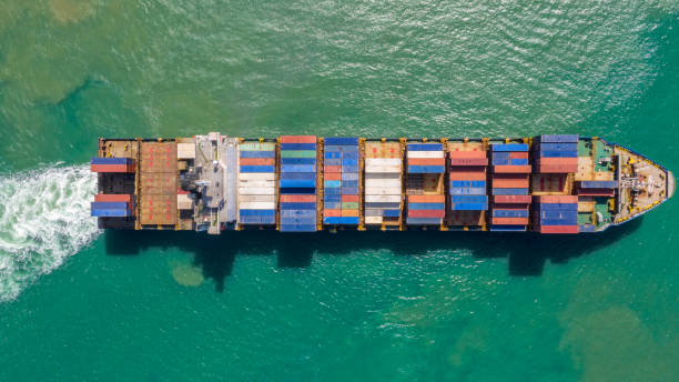 istock Container ship in export and import business logistics and transportation. Cargo and container box shipping to harbor by crane. Water transport International. Aerial view and top view. 1137572848
