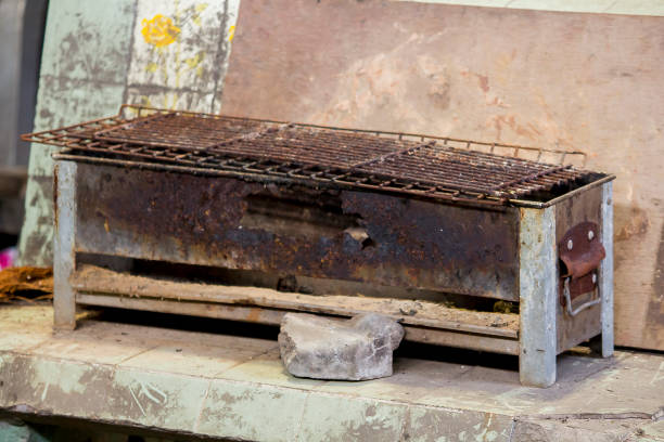 Old grill that is rusty and laid on the floor