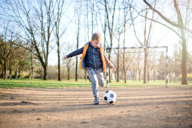 istock Boy play with football ball 1137574295