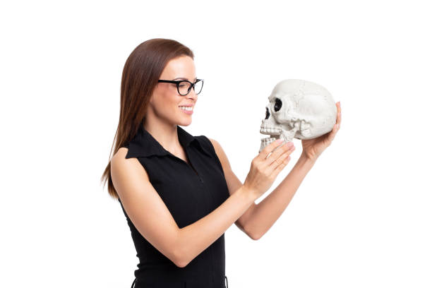 istock Young caucasian woman smiling on skull isolated on white 1137574328