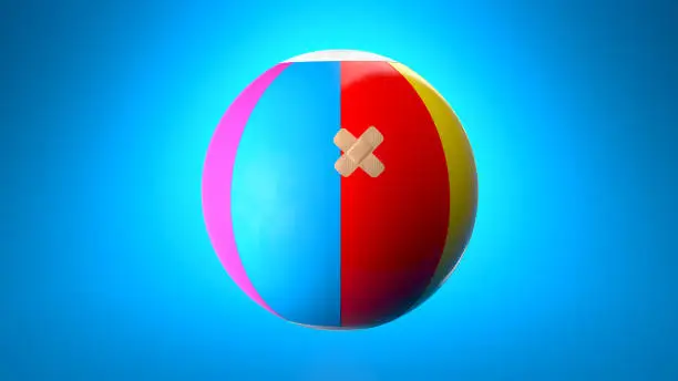 Inflated beachball with a band aid against a blue background