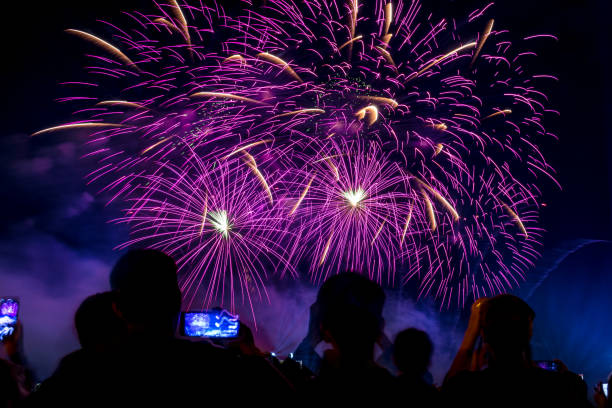 istock Crowd watching fireworks and celebrating city founded. Beautiful colorful fireworks display in the urban for celebration on dark night background. 1137575814