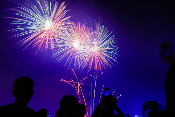 istock Crowd watching fireworks and celebrating city founded. Beautiful colorful fireworks display in the urban for celebration on dark night background. 1137575820