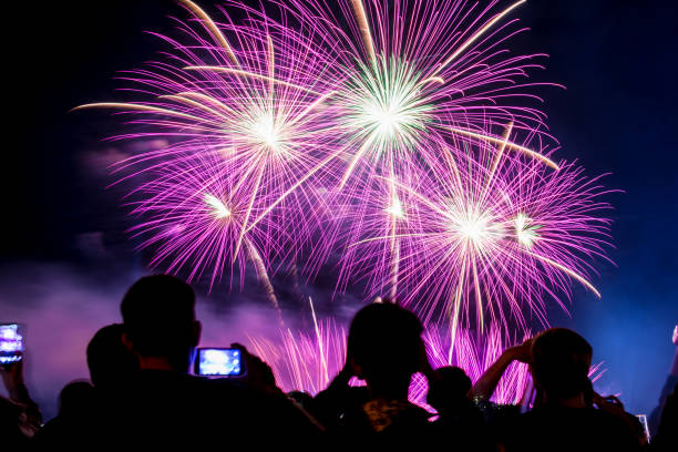 istock Crowd watching fireworks and celebrating city founded. Beautiful colorful fireworks display in the urban for celebration on dark night background. 1137575821