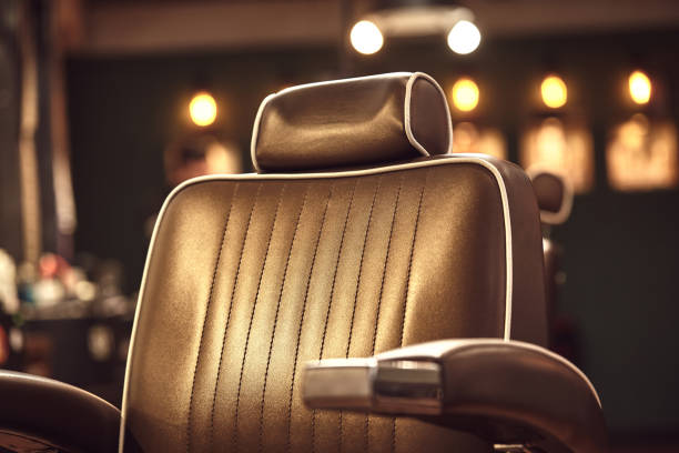 Brown leather chair in barbershop. Loft style stock photo