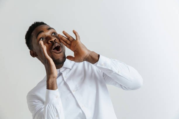istock Wow. Attractive male half-length front portrait on grey studio backgroud. Young afro emotional surprised bearded man 1137577945