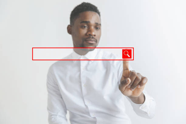istock Young african american guy interacts with empty search bar. Negative space to insert your text. 1137577983