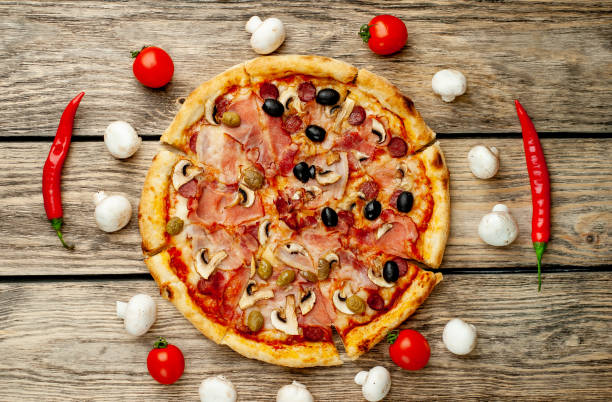 istock Tasty pizza on wooden background 1137578131
