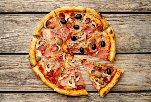 istock Tasty pizza on wooden background 1137578177