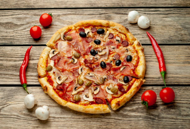 istock Tasty pizza on wooden background 1137578356