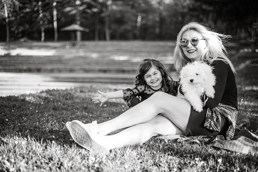 Happy mother and daughter with little dog