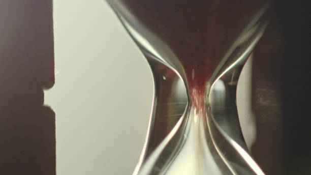 istock Time passing metaphor. Sand falling down in hourglass 1137581590