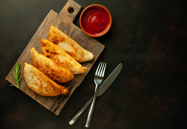 Latin American fried empanadas with tomato sauce.  Top view.Copy space Background for text