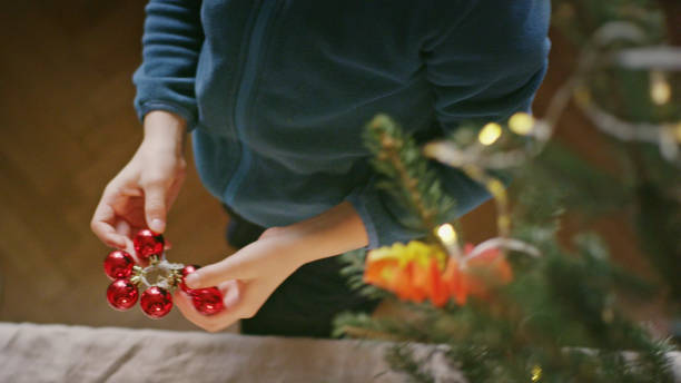 istock Teenage boy undressing Christmas tree 1137583430
