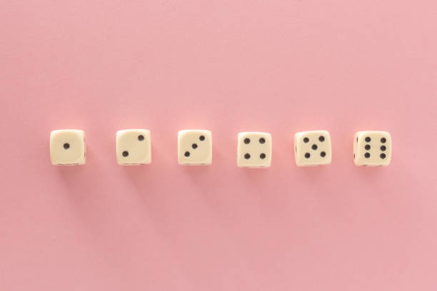 istock White gaming dices on pink background. victory chance, lucky. Flat lay, place for text. Top view. Close-up. Concept gamble. spectacular pastel 1137585697