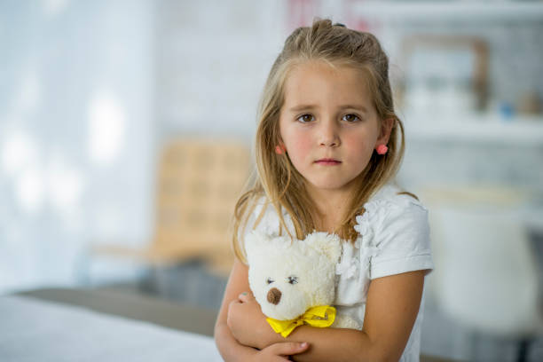 istock Girl Hugging Her Teddy Bear 1137586858