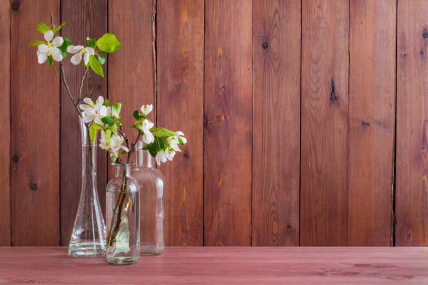 istock Home interior with decor elements. White spring flowers in a vase on a wooden table 1137587835