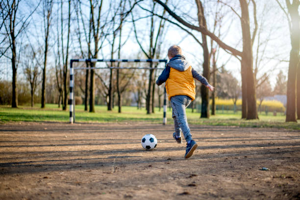 istock Boy playing with soccer ball 1137587907