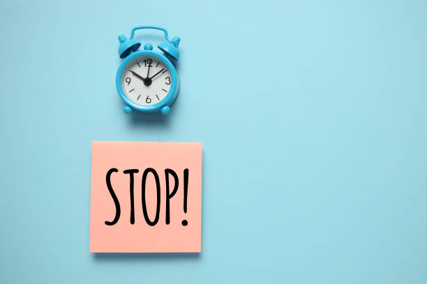 istock Blue alarm clock and paper reminder, stop. Time management, priorities, efficiency, control and goals 1137588890