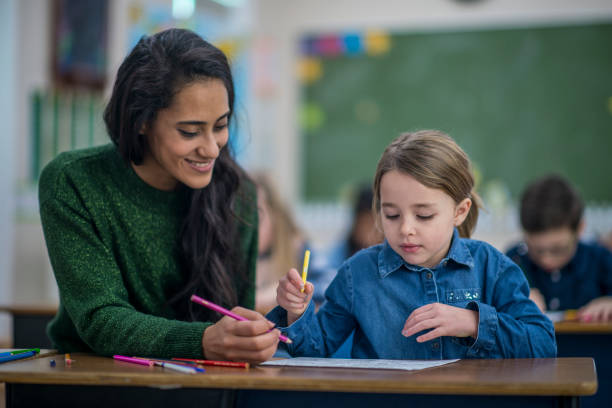 istock Girl Drawing Along With Teacher 1137594488