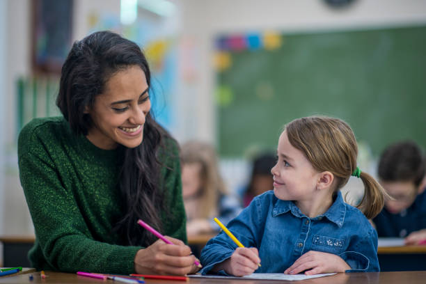istock Girl Drawing Along With Teacher 1137594490