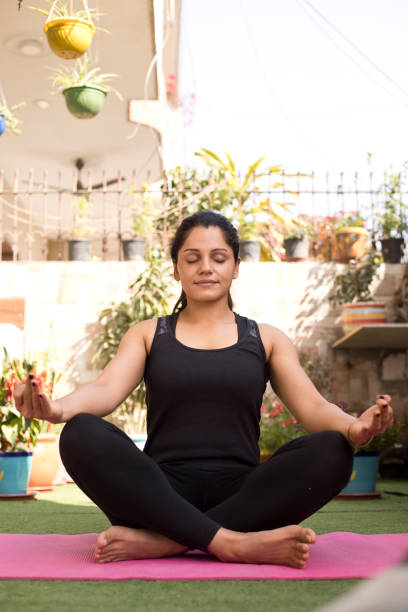 istock One women meditating outdoors 1137594864