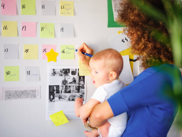 istock Working Mother Balancing Baby and Design Work 1137594937