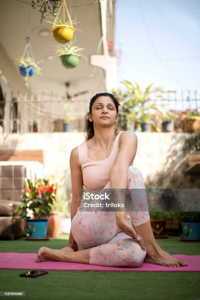 Woman in yoga pose outdoor Exercising Stock Photo