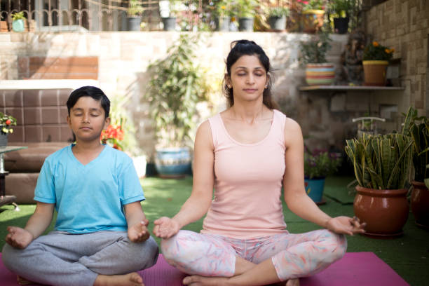istock Mother and son meditating on exercise mat 1137596080