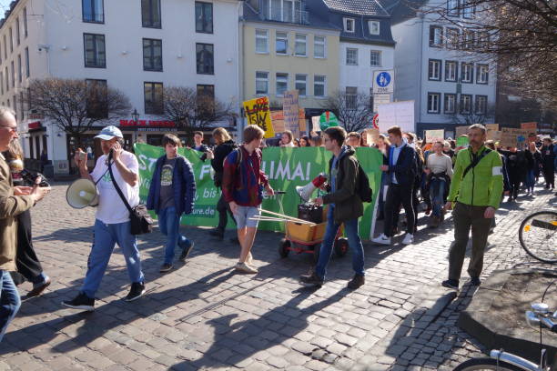 #FridaysForFuture: Pupils 
protest against climate change Duesseldorf, Germany, March 22, 2019: #FridaysForFuture: Unidentified Duesseldorf pupils protest against climate change in front of the city hall and continue their protest procession along the Rhine promenade strike protest action photos stock pictures, royalty-free photos & images